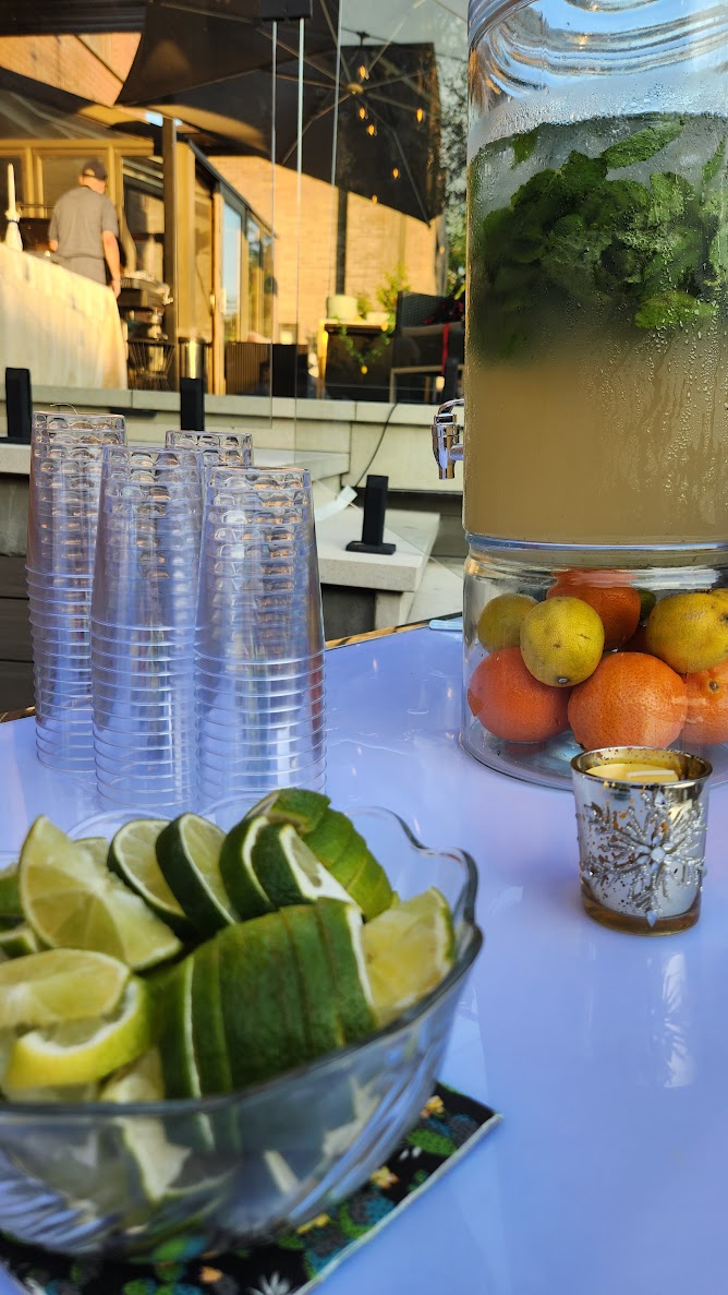 Outdoor bar setup with fresh citrus and beverage service station
