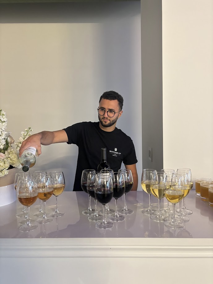 Bartender pouring wine service at elegant event